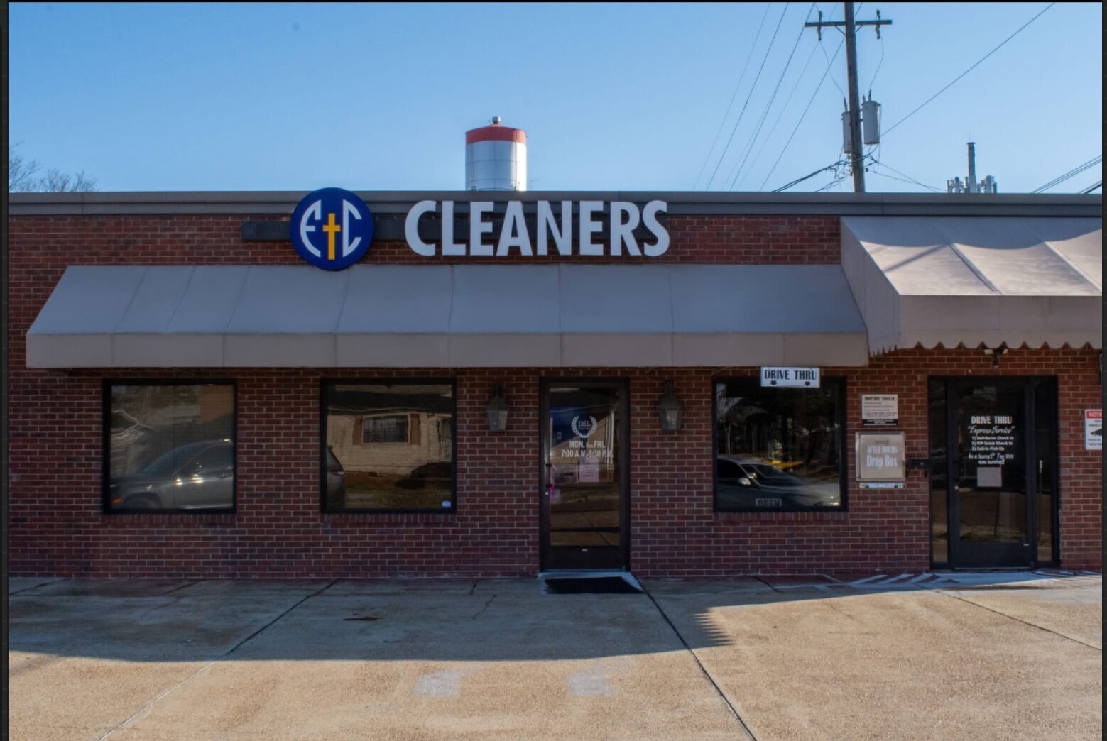 A brick building with a large sign reading 